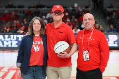 Proud parents: Conrad with his wife, Kristy and son, Tyler, after Tyler was honored at a Houston Men’s Basketball game in recognition of his four years of service as a United States Marine.